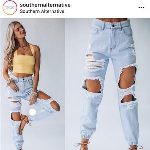 High waisted destroyed jeans , cuffed at ankles